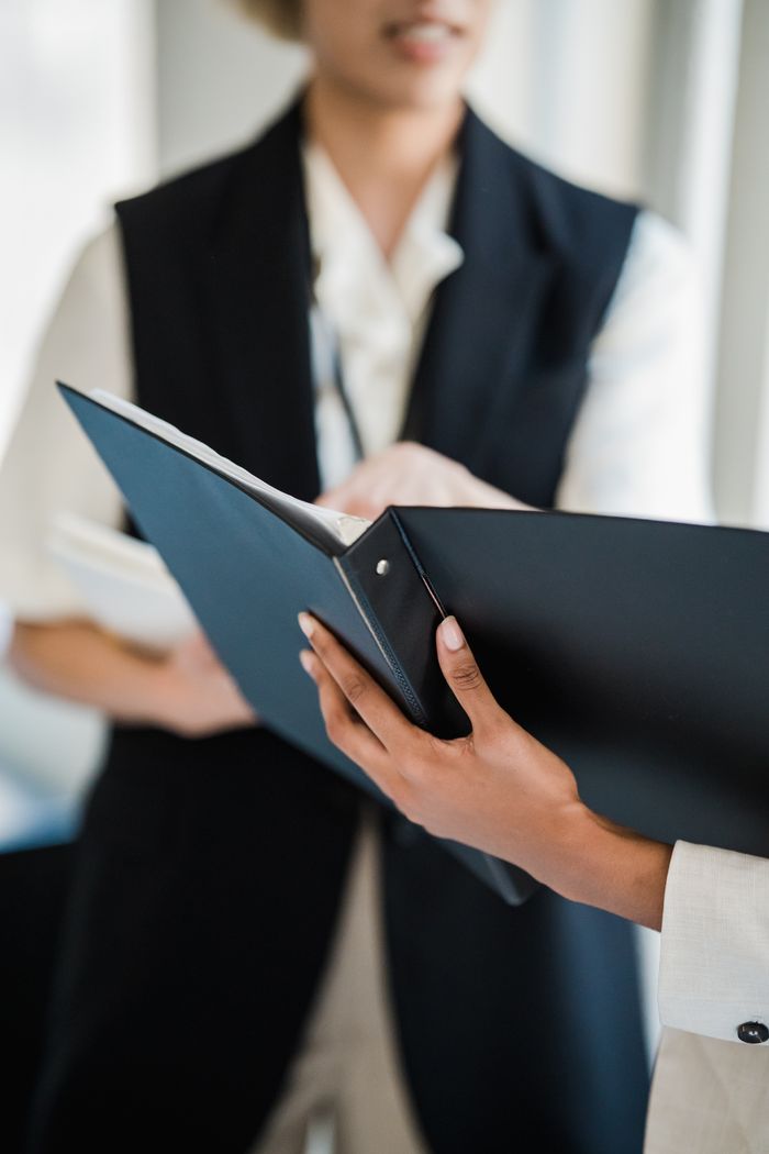 Close-up of professionals discussing documents in an office meeting setting.
