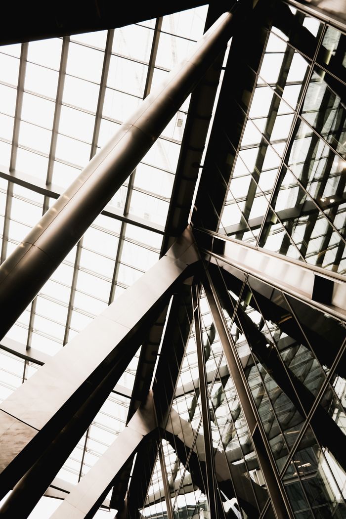Dramatic view of intersecting steel beams in modern architecture, emphasizing geometric design.